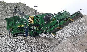 At a sand and gravel plant, sand is falling off a conveyor ...